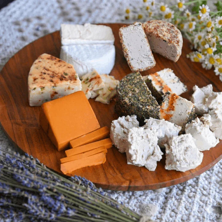 assorted cheeses on a cheese board