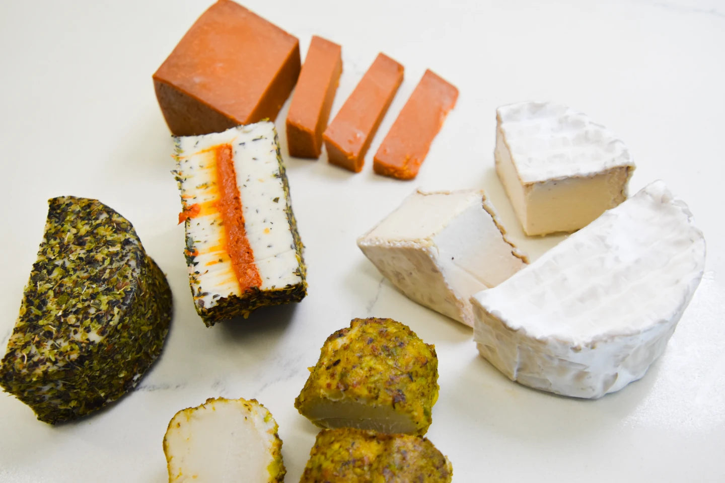 Assorted types of cheese on a white surface