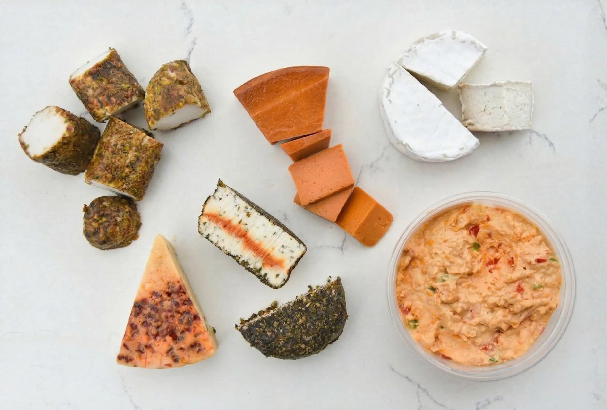 Assorted types of cheese on a white surface