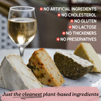 Glass of white wine with cheese slices on a table, emphasizing plant-based ingredients.