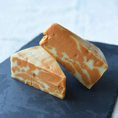 marbled Colby Jack cheese on a black marble platter