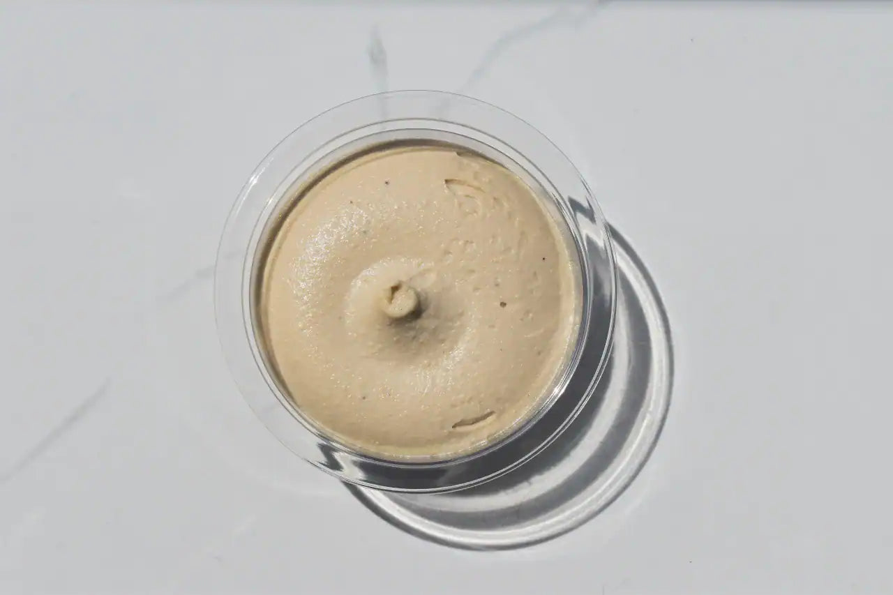 Rebel Cream Cheese in a clear container on a white background