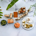 assorted dairy-free cheeses on a cheese board and plate from Rebel Cheese