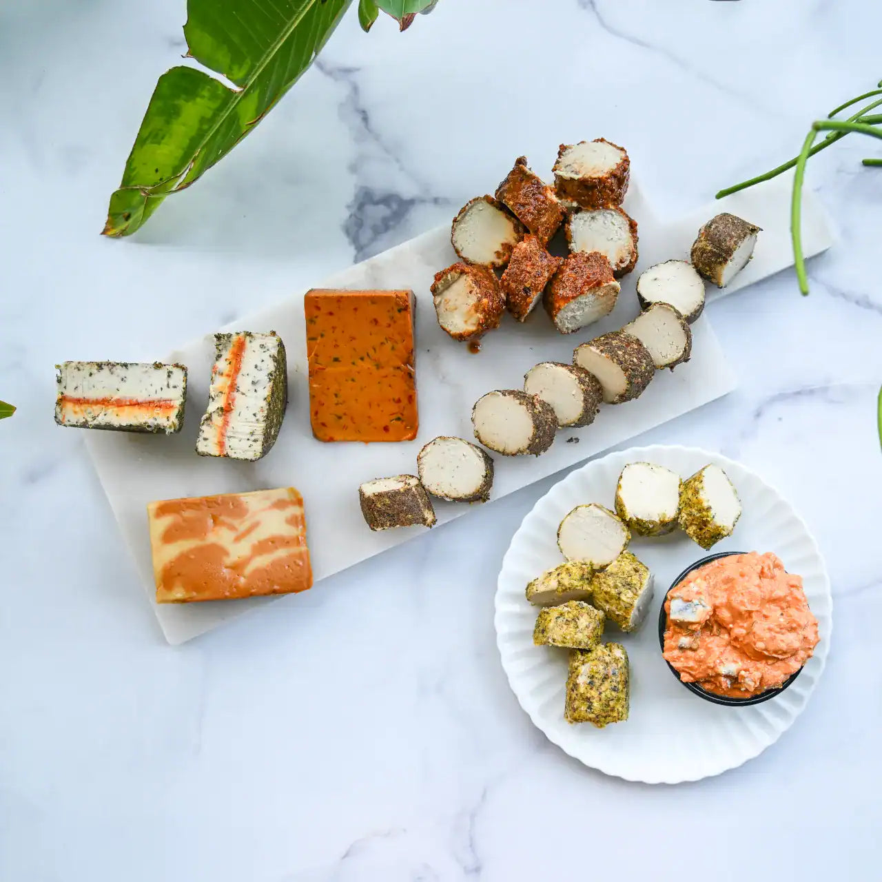assorted dairy-free cheeses on a cheese board and plate from Rebel Cheese