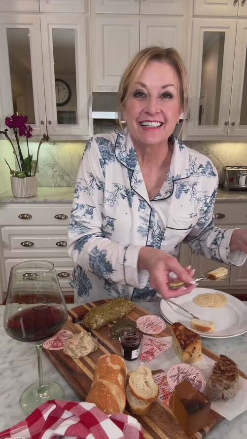 a woman talking about how she enjoys pampering herself with wine and cheese