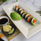 Sliced Rebel Roll vegan cheese showing creamy cashew center and savory nori coating