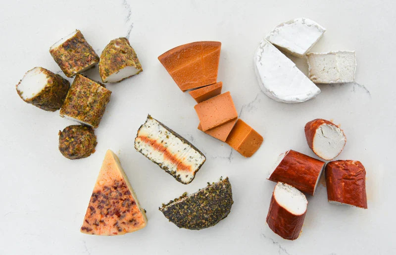 Assorted types of cheese on a light background